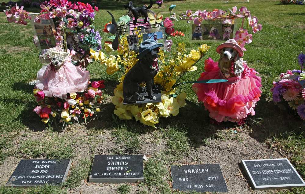 Statues memorialize family pets at the Los Angeles Pet Cemetery in Calabasas, Calif. The Associated Press