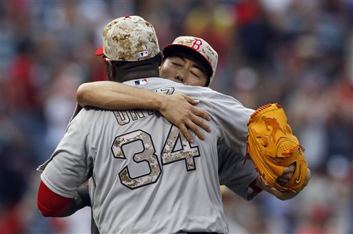 Red Sox pitcher Koji Uehara hugs David Ortiz after Boston defeated the Braves 8-6 Monday in Atlanta.