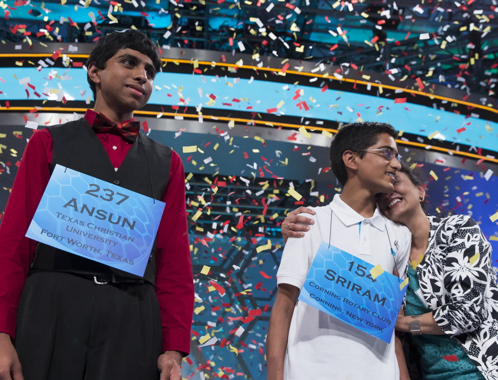 Ansun Sujoe, 13, of Fort Worth, Texas, left, and Sriram Hathwar, 14, of Painted Post, N.Y., will share the title after Thursdayâs National Spelling Bee final in Oxon Hill, Md. The Associated Press