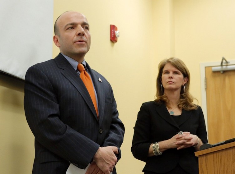 Gary Alexander, founder of the Alexander Group, answers questions in January in Augusta about his analysis. At right is Mary Mayhew, commissioner of the Maine Department of Health and Human Services.