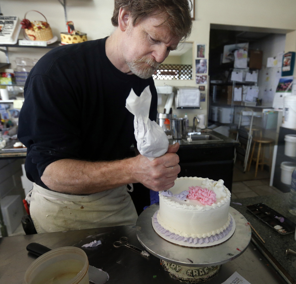 In this March 10, 2014 photo, Masterpiece Cakeshop owner Jack Phillips decorates a cake inside his store, in Lakewood, Colo. Phillips is appealing a recent ruling against him in a legal complaint filed with the Colorado Civil Rights Commission by a gay couple he refused to make a wedding cake for, based on his religious beliefs. The Associated Press/Brennan Linsley