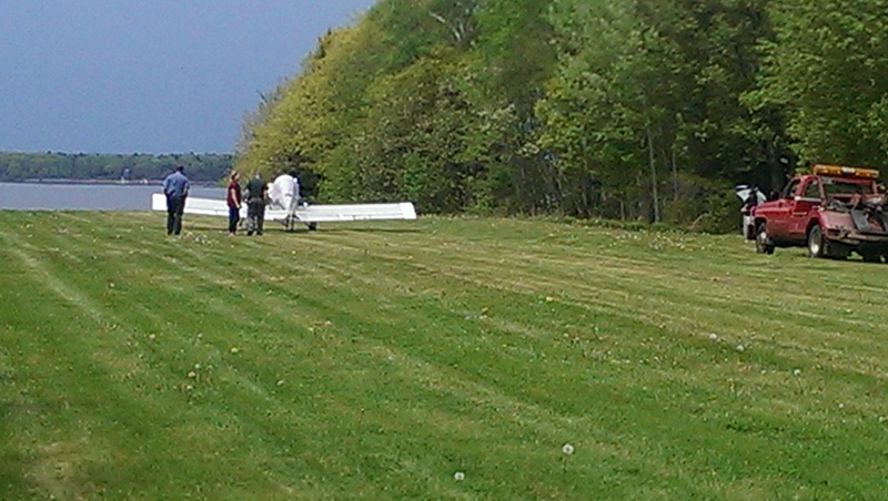 Plane in Harpswell at the end of a grass landing strip.