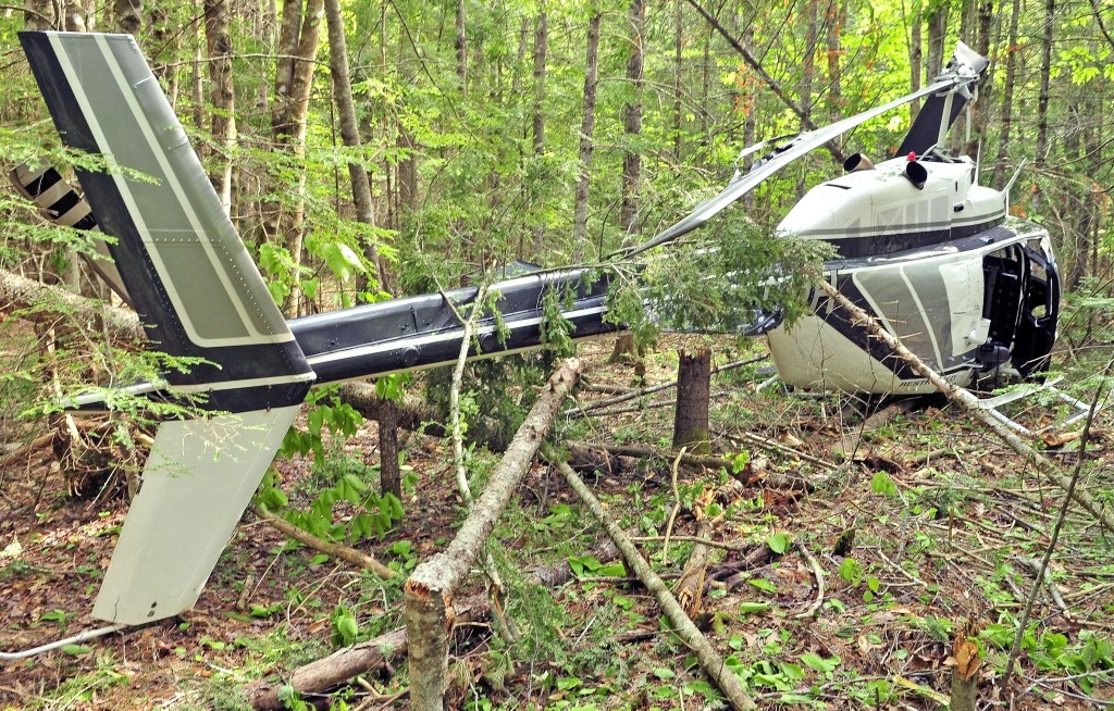 A helicopter sits in the wood after a crash landing on Friday in Whitefield. 