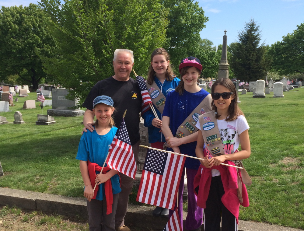 Clockwise from left, Abigail Freese, VFW Post 832 of South Portland Commander Sam Flint, Emily Freese, Laura LeFebvre and Mackenzie Farnham were among a group of 26 people who volunteered to place flags at the graves of 930 veterans at five South Portland cemeteries in observance of Memorial Day. Photo courtesy Amy Freese