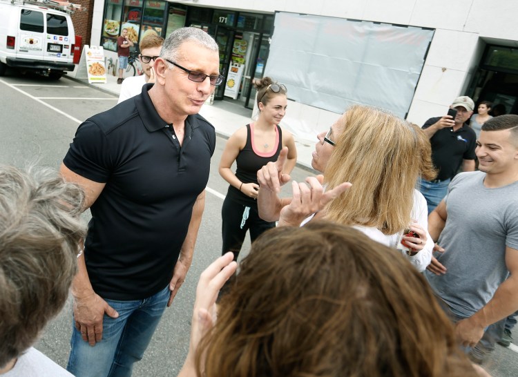 Robert Irvine, host of Restaurant Impossible, visits with fans outside of Uncle Andy's in South Portland on Tuesday.