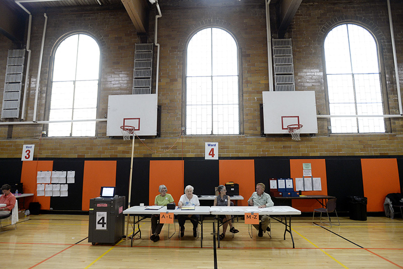 Left to right, ward clerk Anne Strout and ward workers Barbara Jackson, Ruth Boissonnault and Alfred Martel sit at their posts and wait for voters at the J. Richard Martin Community Center in Biddeford on Tuesday.  