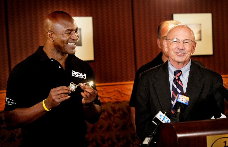 Former five-time heavyweight boxing champion Evander Holyfield shows off the key to the city after Portland Mayor Michael Brennan gave it to him during a ceremony at the Portland Regency Hotel and Spa on Friday,