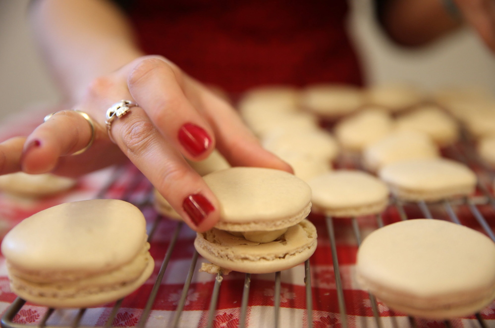 Heather Schroering finishes her macarons with a vanilla filling during class at the Alliance Francaise de Chicago.