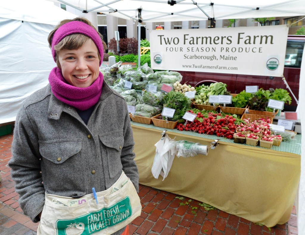 Kelsey Herrington in front of her stand at the farmers market in Portland’s Monument Square. John Patriquin/Staff Photographer