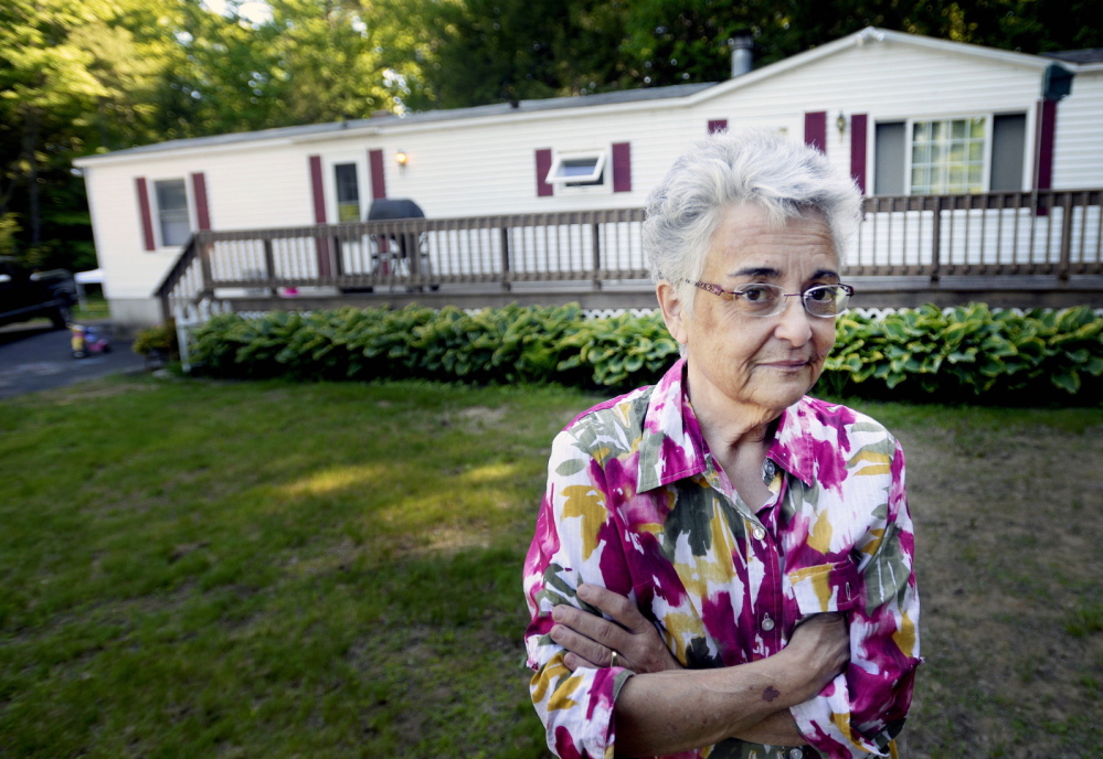 Deborah Nielsen stands outside her home in Buxton, where she was assaulted and tied up after interrupting a burglary in April. Even though charges against three suspects have been dropped, she says she still has faith in the police.
Shawn Patrick Ouellette/Staff Photographer
