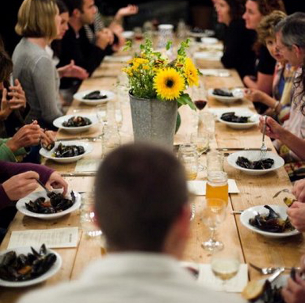 Diners at Salt Water Farm’s events share a communal table, fresh farmed and foraged food, and ocean views.