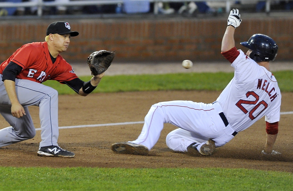Stefan Welch of the Portland Sea Dogs slides safely into third base with a triple as Corey Jones of the Erie SeaWolves waits for the ball Thursday night at Hadlock Field. Welch tripled twice in a 5-3 victory. Gordon Chibroski/Staff Photographer