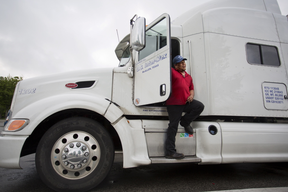 Truck driver Cesar Solis, 42, stops Thursday at the Maine Turnpike service plaza in Kennebunk. He said his pay fell when new driver rest rules took effect last summer, but he understands the need for safety and he doesn’t push the limits. Gabe Souza/Staff Photographer