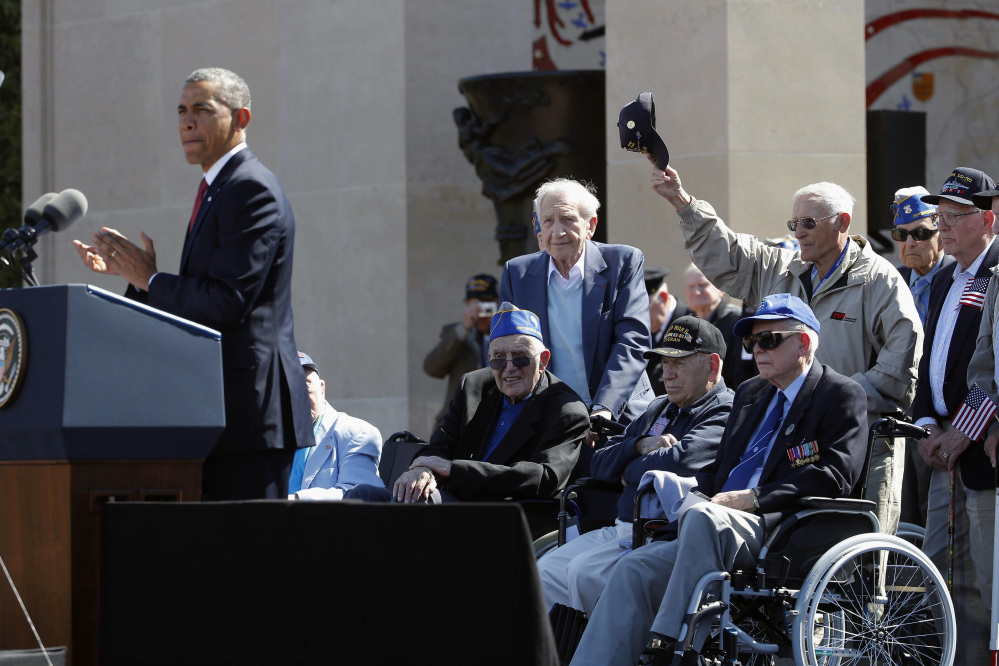 The Associated Press President Barack Obama acknowledges veterans as he speaks at the Normandy American Cemetery at Omaha Beach Friday.