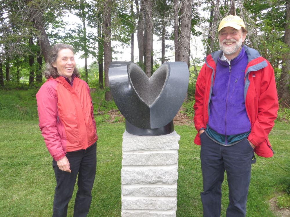 Lucy Hull and Bart Chapin of Arrowsic at Gilsland Farm, beside “Euphoria” by their son Miles Chapin, a stone sculptor who lives in Vermont.