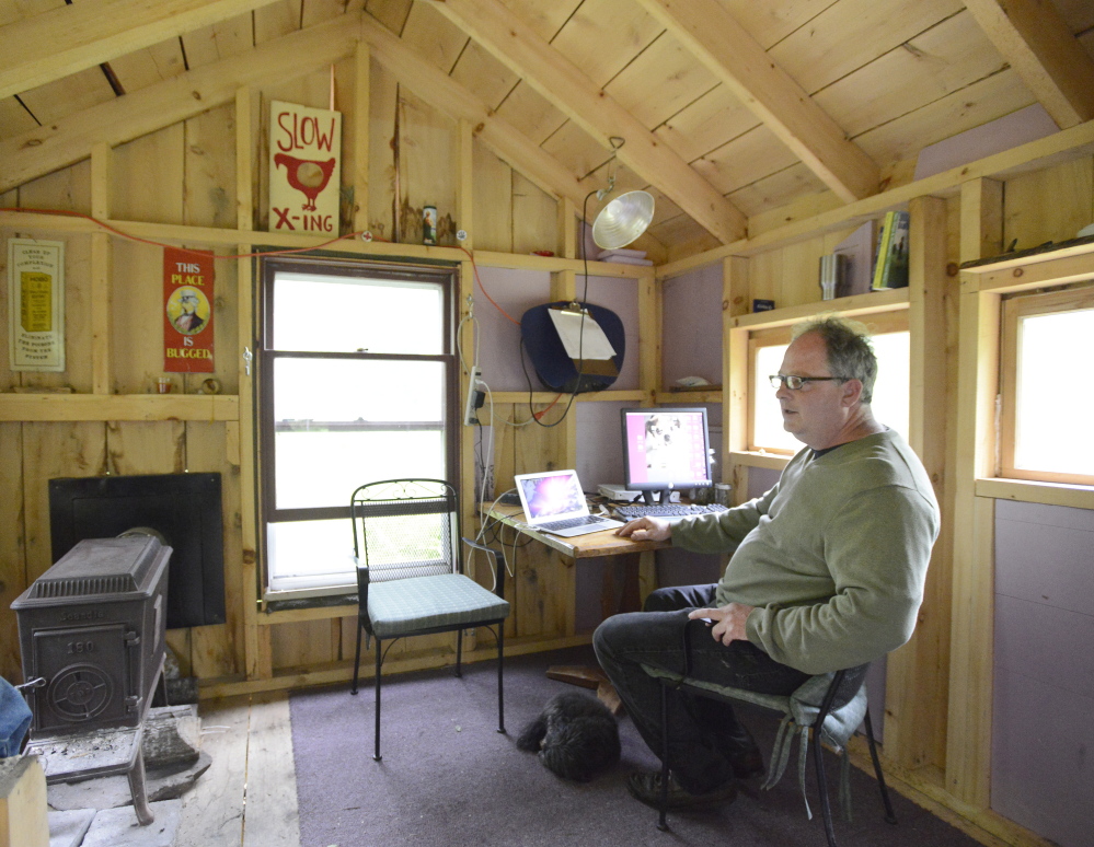 Crash Barry in the writing studio that he built a few hundred yards from his home in Oxford County that is made of wood milled from trees that the writer felled himself. John Patriquin/Staff Photographer