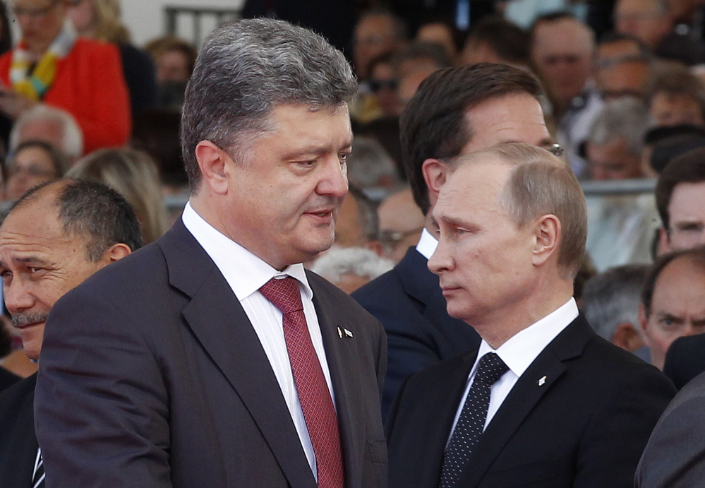  Ukraine President-elect Petro Poroshenko, left, walks past Russian President Vladimir Putin at Friday’s commemoration of the 70th anniversary of D-Day in Ouistreham, France. The Associated Press