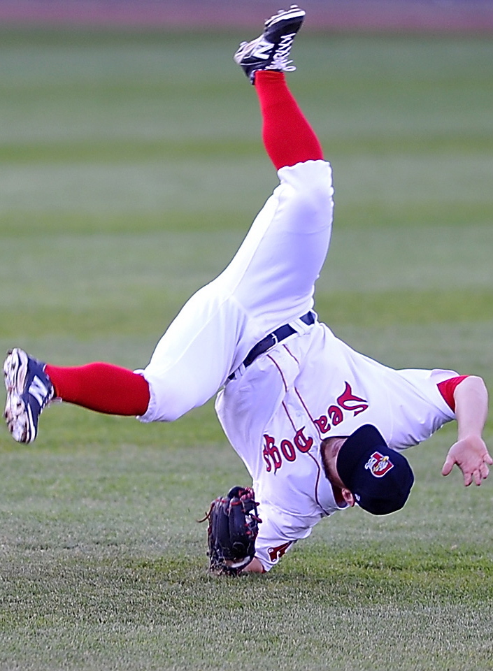 Second baseman Sean Coyle of the Portland Sea Dogs cartwheels across the field Friday night after making a diving catch against the Bowie Baysox at Hadlock Field. The Sea Dogs failed to come up with clutch hits and suffered a 6-4 setback. Gordon Chibroski/Staff photographer