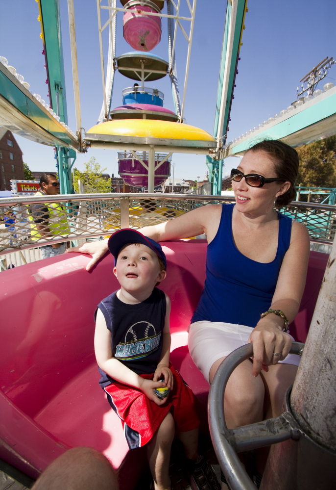 Alec Hanson, 3, and his mother, Teresa Hanson of Westbrook, ride the Ferris wheel near Commercial Street during the Old Port Festival in Portland on Saturday. Carl D. Walsh / Staff Photographer