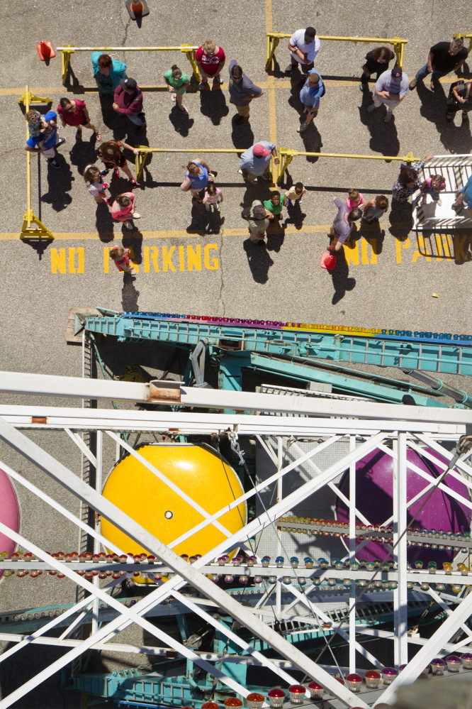 People wait to ride the Ferris wheel near Commercial Street during the Old Port Festival in Portland on Saturday. Carl D. Walsh / Staff Photographer