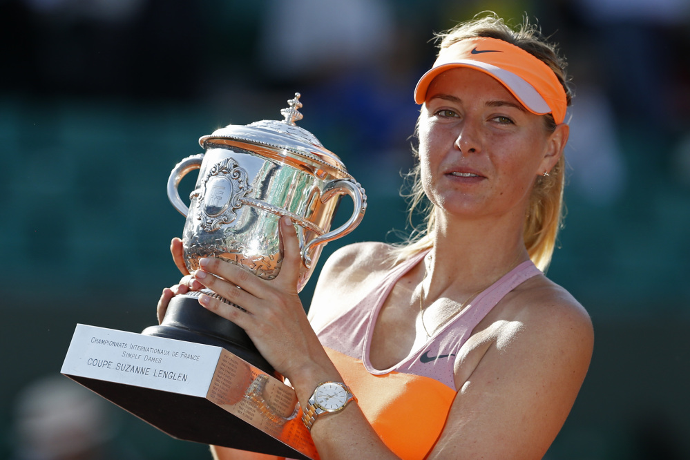 The Associated Press Russia’s Maria Sharapova holds the trophy  after winning the final of the French Open tennis tournament against Romania’s Simona Halep at the Roland Garros stadium, in Paris, France, Saturday.