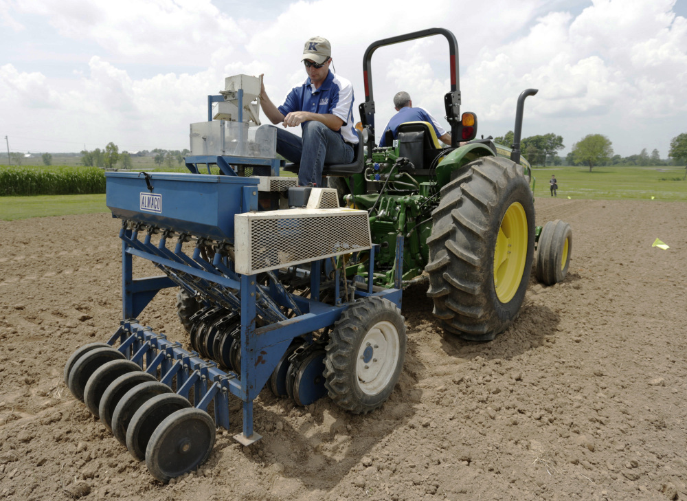 Richard Mundell sits on a plot seeder pulled by a tractor driven by Mark Sizemore, as they plant hemp seeds at the UK Spindletop Research Farm off of Newtown Pike in Lexington, Ky., on Tuesday, May 27, 2014. The Associated Press/The Lexington Herald-Leader, Pablo Alcala