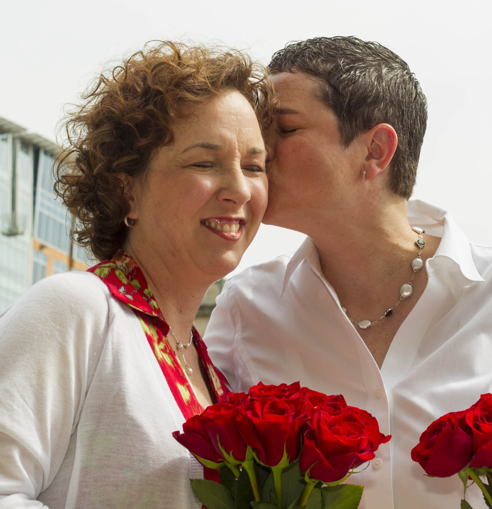 Kerry Lehman, right, kisses Sara Hinkel, after they wed Saturday in Madison, Wis. A judge struck down the state’s ban on gay marriage Friday. The Associated Press 
