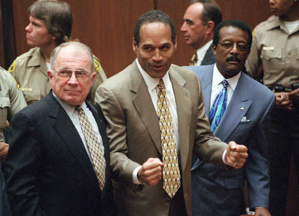 O.J. Simpson reacts as he is found not guilty of murder in Los Angeles on Oct. 3, 1995. At left is defense lawyer F. Lee Bailey and at right is defense attorney Johnnie Cochran Jr. The Associated Press 