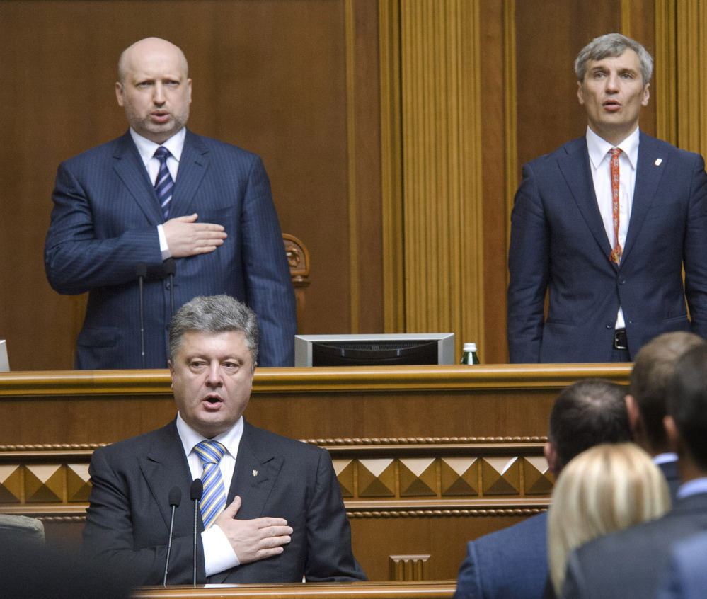 Ukrainian President-elect Petro Poroshenko, foreground, sings the national anthem during his inauguration ceremony in Kiev, Ukraine, on Saturday.
The Associated Press