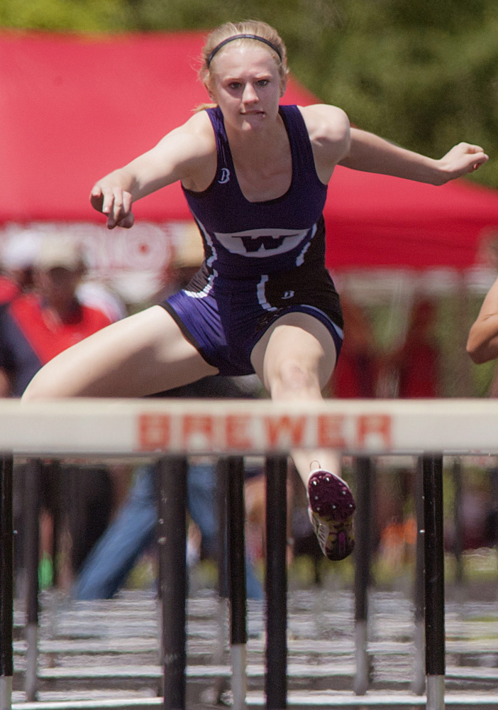 Sarah Shoulta of Waterville clears a hurdle on the way to victory Saturday in the 100-meter hurdles. Michael C. York/Special to the Telegram 