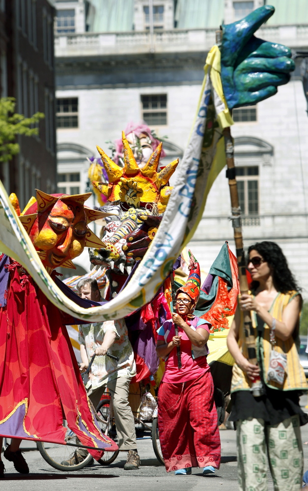 The Kick Off Parade proceeds down Exchange Street, featuring the Shoestring Theater with dancers, drummers and mascots at the Old Port Festival in Portland on Sunday. Tim Greenway/Staff Photographer