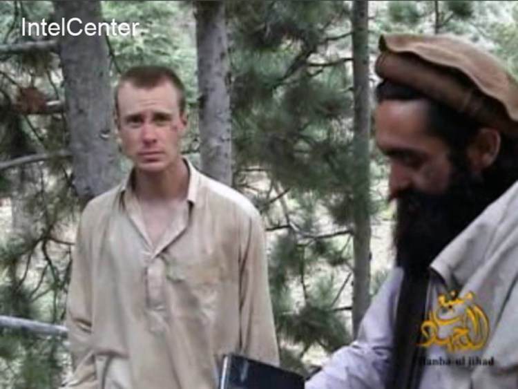 This file image made from video released by the Taliban and obtained by IntelCenter on Dec. 8, 2010, shows a man believed to be Bowe Bergdahl at left. The Associated Press