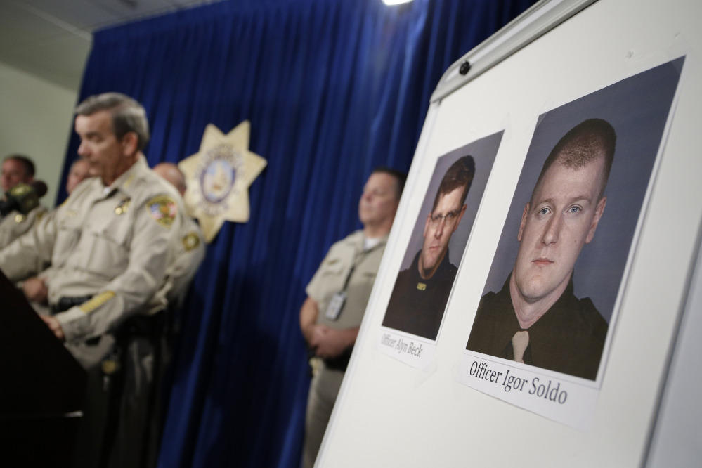 Sheriff Doug Gillespie, left, speaks at a news conference on the shooting of two Las Vegas Metropolitan Police Department officers Sunday in Las Vegas. The two officer killed were Alyn Beck and Igor Soldo. The Associated Press 