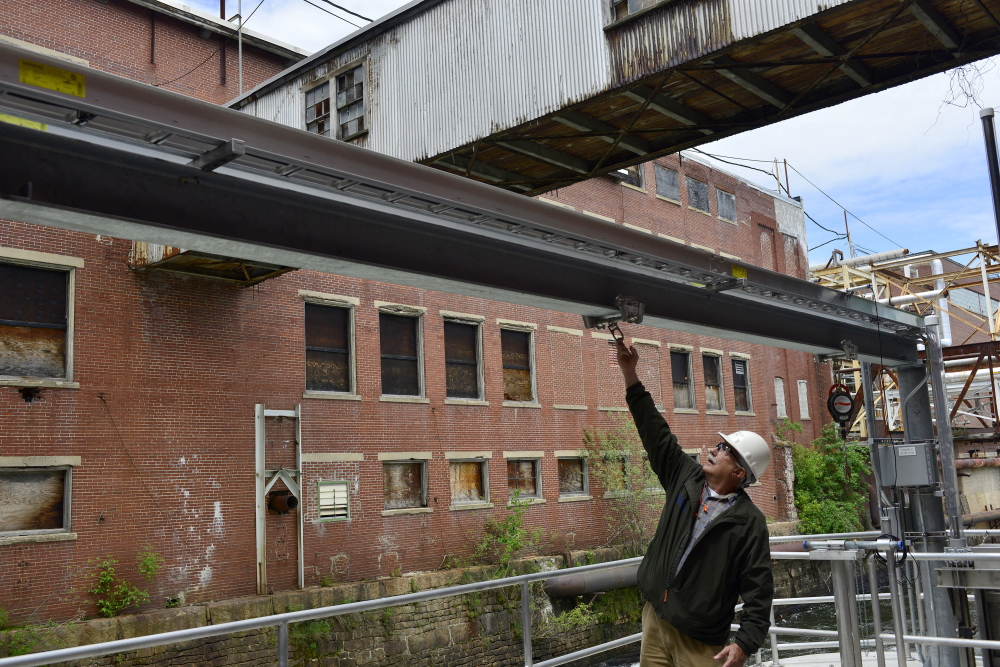 Barry Stemm, project manager with Sappi Fine Paper in Westbrook, inspects tracks on the company's fish passage, which has been in operation for just over a year.