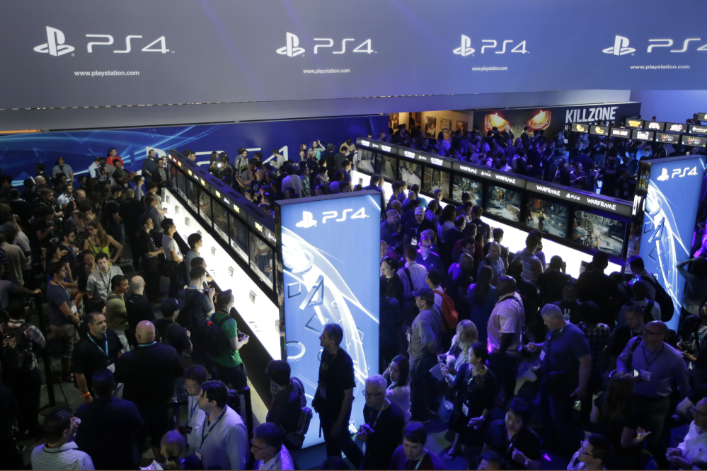 The Associated Press In this June 11, 2013 file photo, show attendees play video games on the new Sony PlayStation 4 at the Sony booth during the Electronic Entertainment Expo, in Los Angeles.