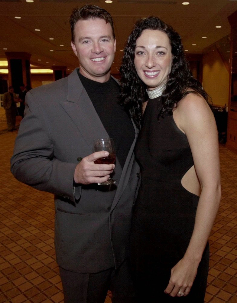 In this March 1, 2001 file photo, six-time Olympic gold medalist swimmer Amy Van Dyken, right, and Denver Broncos punter Tom Rouen pose before going into the Colorado Sports Hall of Fame dinner in Denver. The Associated Press/David Zalubowski