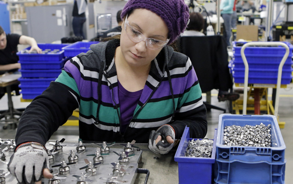Evelyn Morales assembles blender blades earlier this year at the Vitamix manufacturing facility in Strongsville, Ohio. The Associated Press