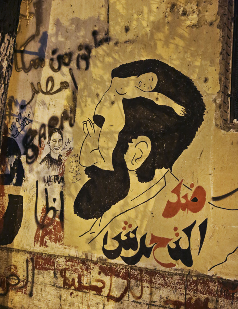 Anti-sexual harassment graffiti sits on a wall near Tahrir Square in Cairo. Egyptian police on Monday arrested seven men for sexually assaulting a 19-year-old student. The Associated Press 
