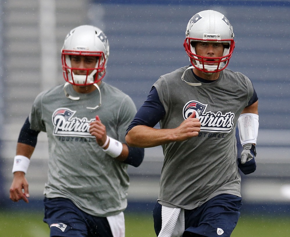 Tom Brady, right, and Jimmy Garoppolo work out during Patriots’ practice Monday in Foxborough, Mass. Brady is trying to rebound from a disappointing 2013 season. The Associated Press