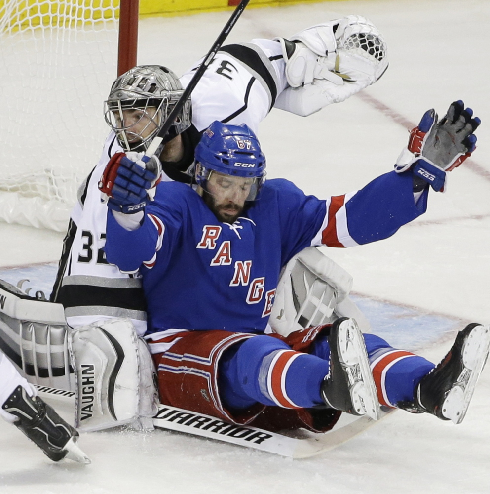 New York Rangers right wing Martin St. Louis, right, falls back into Los Angeles Kings goalie Jonathan Quick in the second period of Game 3 of the Stanley Cup Monday at New York. Quick made 32 saves as the Kings won 3-0. The Associated Press 