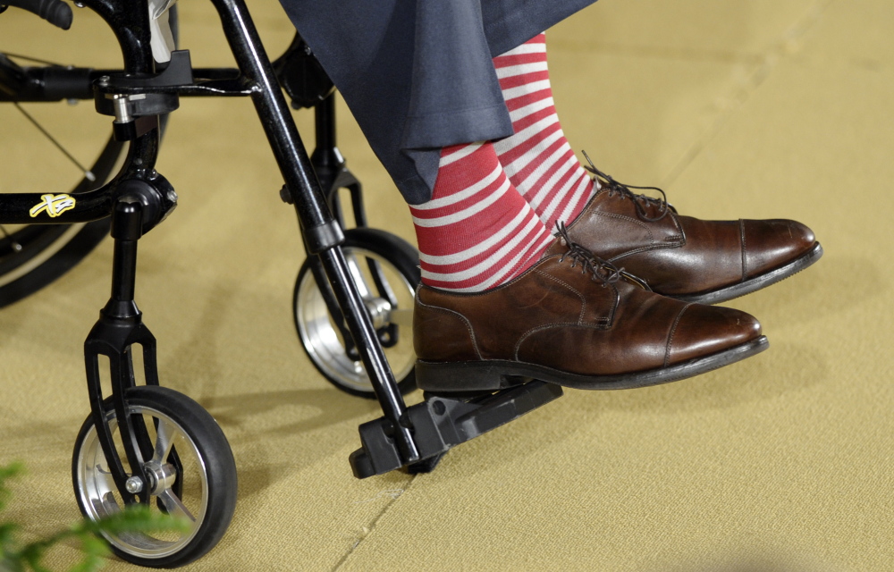 The Associated Press Former President George H.W. Bush wears a pair of striped socks to a ceremony for his Thousand Points of Light initiative in the East Room of the White House in this July 2013 photo.