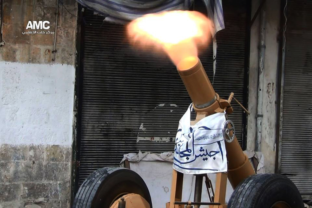 This photo provided by the anti-government activist group Aleppo Media Center (AMC), which has been authenticated based on its contents and other AP reporting, shows a locally made shell being fired by the Free Syrian Army towards Syrian government forces, in Aleppo, Syria, Tuesday June 10, 2014. Fighting in eastern Syria between the Islamic rebel brigades and an al-Qaida splinter group has killed more than 630 people and uprooted at least 130,000 since the end of April, an activist group said Tuesday. The Associated Press/Aleppo Media Center
