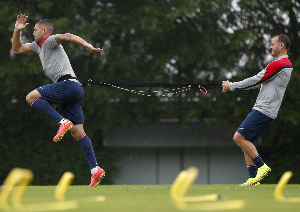 United States’ Clint Dempsey, left, and Brad Davis work on resistance exercises during a training session at the Sao Paulo FC training center in Sao Paulo, Brazil, on Tuesday. The U.S. will play in group G of the 2014 soccer World Cup.