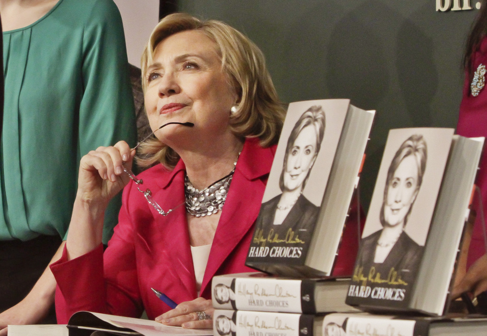 HiIlary Rodham Clinton listens to a supporter as she signs a copy of her new book, “Hard Choices,” on Tuesday at the Barnes and Noble bookstore in New York. The Associated Press 
