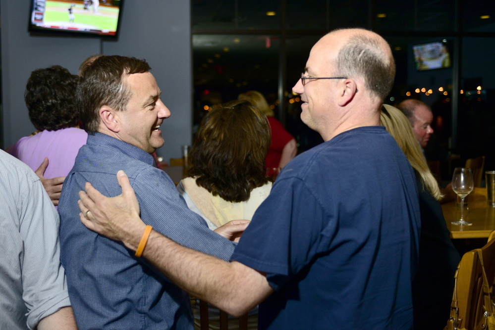 Logan Werlinger/Staff Photographer Michael Edes talks with supporters during his primary party Tuesday night at Easy Day in South Portland. “I’m getting ready for a good, long fishing trip,” Edes said.