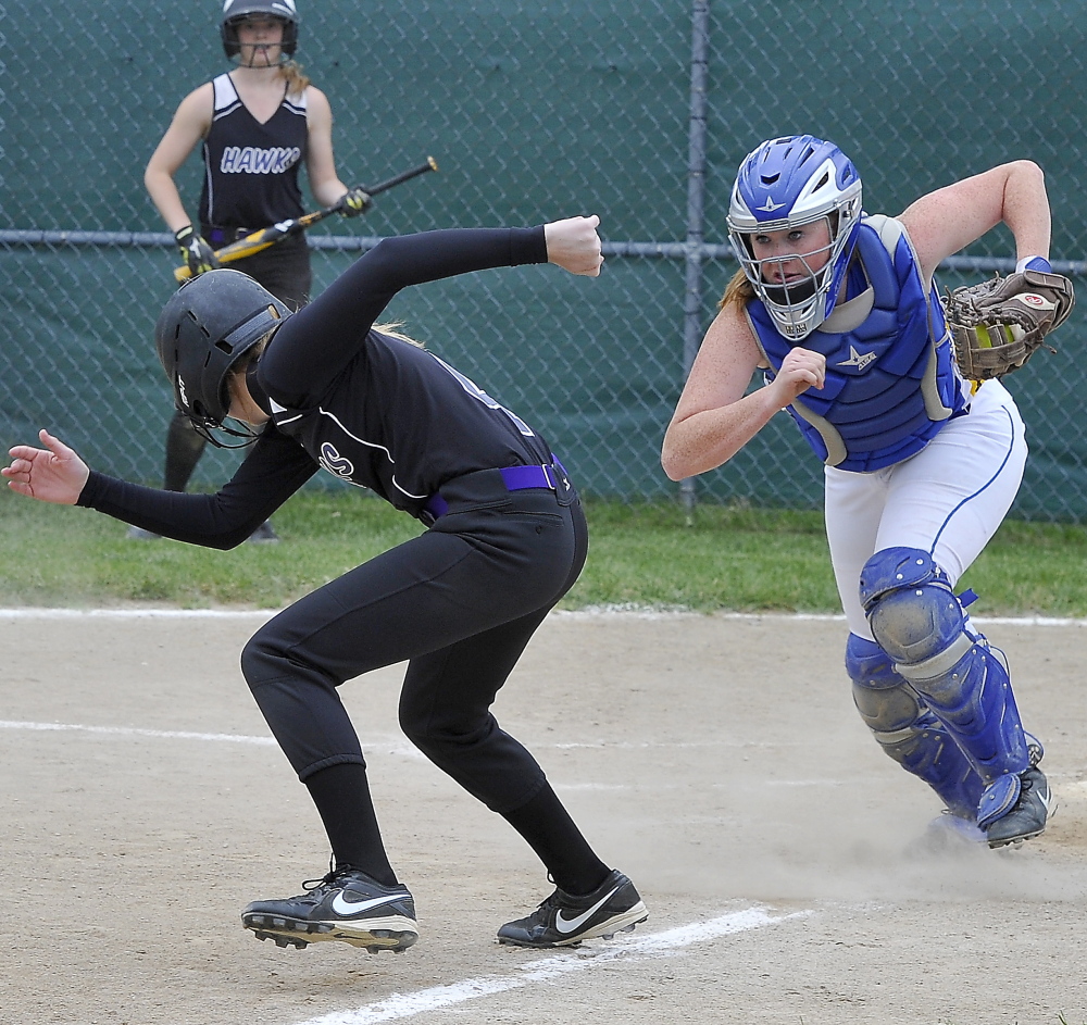  Jen Gray of Marshwood attempts to reverse direction and head back to third base Tuesday after seeing Falmouth catcher Jessica Collins hold the ball. Marshwood downed the Yachtsmen 8-3 in a Western Class A prelim. Gordon Chibroski/Staff photographer