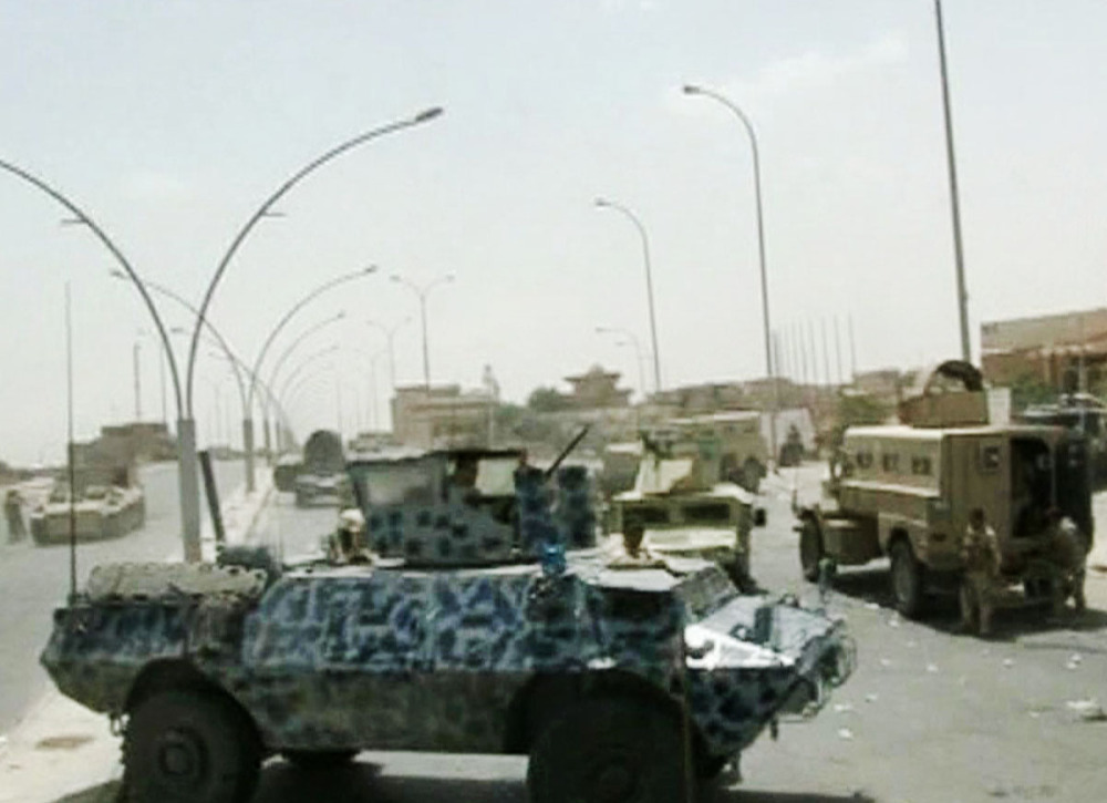 The Associated Press In image taken from video obtained from the Iraqi Military, armored and military vehicles take position on a street during clashes with militants in the northern city of Mosul, Iraq.