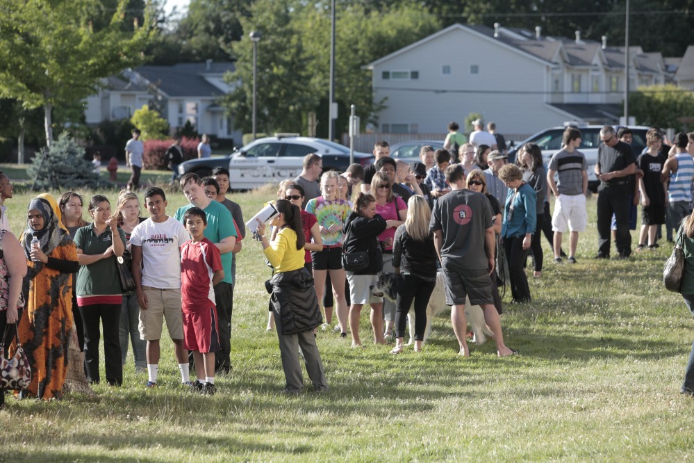 Students and family line up to receive personal property at the north gym of Reynolds Middle School on Tuesday evening, June 10, 2014. A teen gunman armed with a rifle shot and killed a 14-year-old student Tuesday and injured a teacher before he likely killed himself at a high school in a quiet Columbia River town in Oregon, authorities said. (AP Photo/The Oregonian, Michael Lloyd)