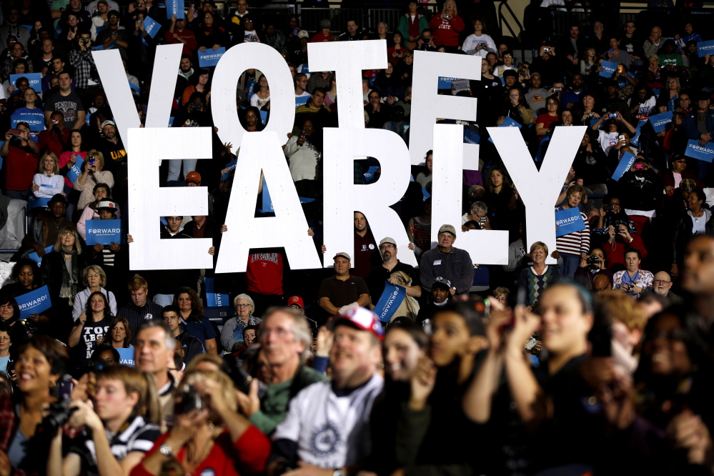 In this Oct. 29, 2012 file photo a “Vote Early” sign is held up by supporters at a rally for President Barack Obama in Youngstown, Ohio. In key swing states this year, Democrats who want to expand early voting and Republicans who want to limit it, are battling to gain even the slightest electoral advantages by tinkering with the times, dates and places where people can vote early. Ohio’s Republican-controlled legislature has taken recent steps, which are being challenged by both the American Civil Liberties Union and the U.S. Justice Department, to curtail early voting on weekends.
