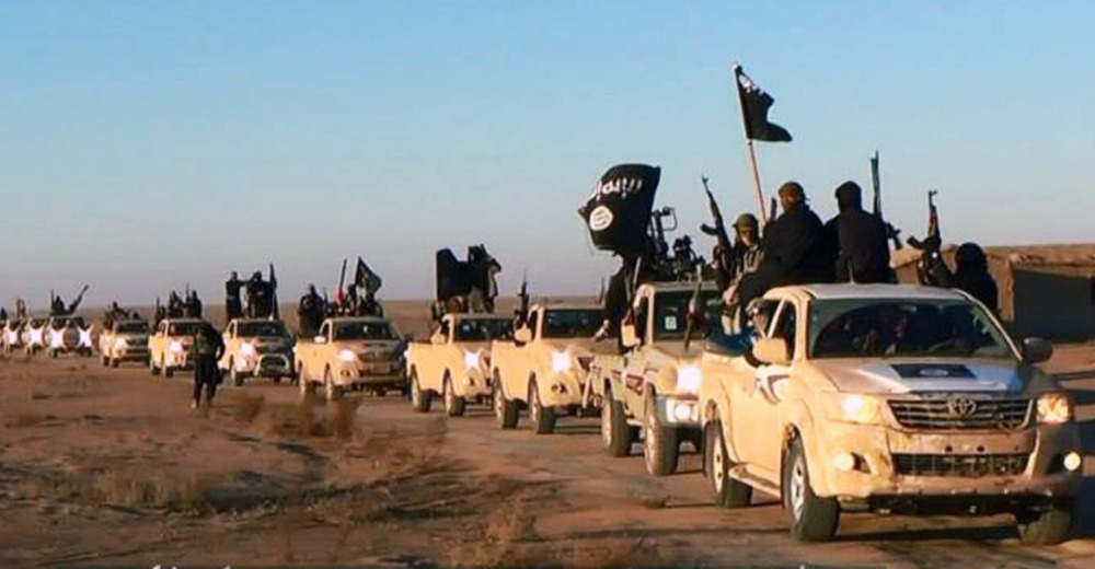 This file image posted on a militant website in January 2014, which is consistent with AP reporting, shows a convoy of vehicles and fighters from the former al-Qaida affiliate Islamic State of Iraq and the Levant in Iraq’s Anbar Province.
